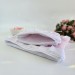 Soft pink laptop sleeve with ruffles, bows and pearl-like beads