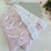 Soft pink tablet sleeve with ruffles, bows and pearl-like beads