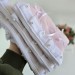 Soft pink tablet sleeve with ruffles, bows and pearl-like beads