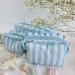 Large sky-blue striped cosmetic bag with ruffles