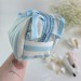Large sky-blue striped cosmetic bag with ruffles