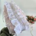 Large soft pink cosmetic bag with ruffles, bows and pearl-like beads
