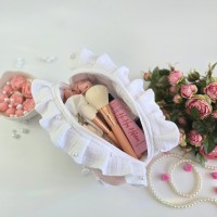 Medium soft pink cosmetic bag with ruffles, bows and pearl-like beads