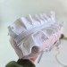 Medium soft pink cosmetic bag with ruffles, bows and pearl-like beads