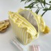Medium yellow striped cosmetic bag with ruffles