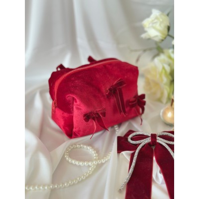 Small red velvet cosmetic bag with bows
