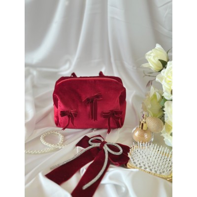 Small red velvet cosmetic bag with bows