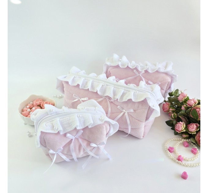 Small soft pink cosmetic bag with ruffles, bows and pearl-like beads